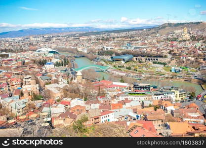 Tbilisi city panorama. Beautiful view of old city. Summer Cityscape.. Old city, new Summer Rike park, river Kura, the European Square and the Bridge of Peace