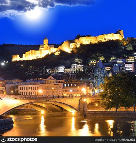 Tbilisi Old Town. Historic district of the capital of Georgia at night against the dark blue sky.