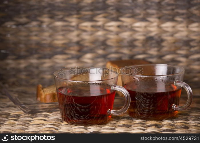 Tea and cake on wooden table in front of a wooden background