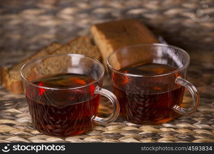 Tea and cake on wooden table in front of a wooden background