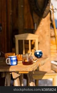 Tea and cake on wooden table winter cottage outdoor