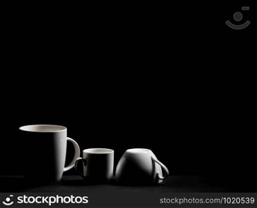 Tea and coffee cups on black background, with place for copy text or image insert