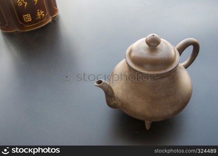 Tea and tea storage placed directly across the black table