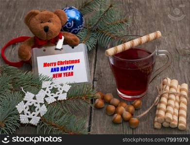 tea, baking, nutlets and a toy bear with a label, the subject Christmas and New Year