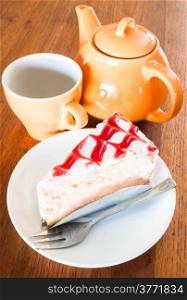 Tea break with white chocolate cake on wood table