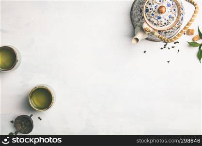 Tea composition, green tea on grey concrete background, flat lay. Tea composition on grey background, flat lay