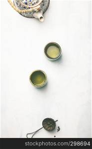 Tea composition, green tea on grey concrete background, flat lay. Tea composition on grey background, flat lay