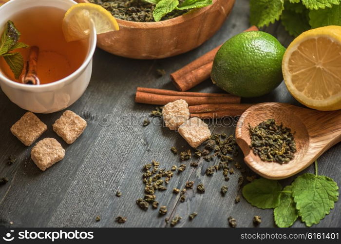 tea composition with cinnamon sticks, lemons