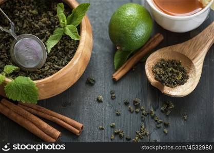 tea composition with cinnamon sticks, lemons and lime