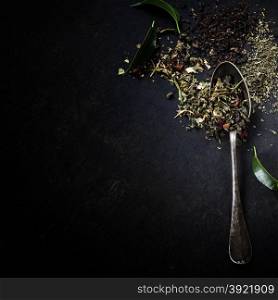 Tea composition with old spoon on dark background