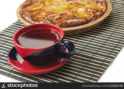 tea cup and apple pie on a dark napkin