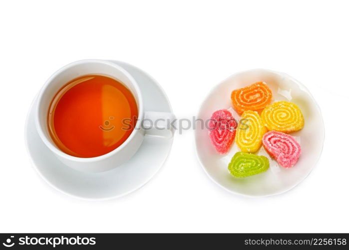 Tea cup and sweets isolated on white background. View from above.