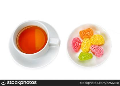 Tea cup and sweets isolated on white background. View from above.