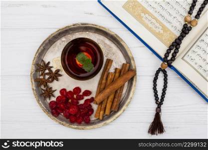 tea cup with cinnamon quran table