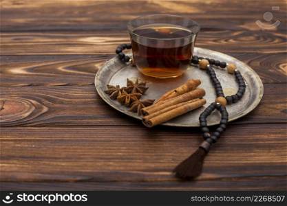 tea cup with cinnamon rosary beads plate