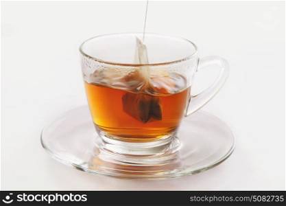 Tea cup with tea bag on white background