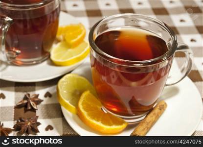 Tea cups at the table with slice of orange and lemon