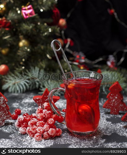 tea from fresh red viburnum in a transparent glass