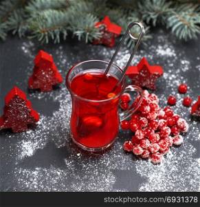 tea from fresh red viburnum in a transparent glass, top view