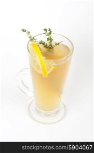 Tea glass. tea glass with thyme lemon on a white