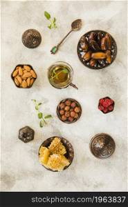 tea glass with dates fruit nuts table. High resolution photo. tea glass with dates fruit nuts table. High quality photo