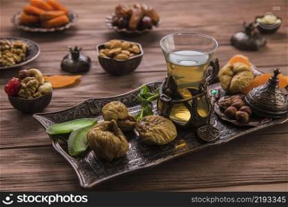 tea glass with dried figs nuts tray