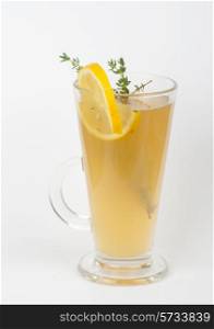 tea glass with thyme lemon on a white
