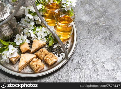 Tea glasses and pot, traditional sweets. Islamic holidays decoration