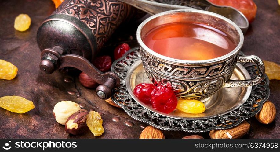 Tea in east style. Arabic tea with nuts and oriental sweets.Tea still life