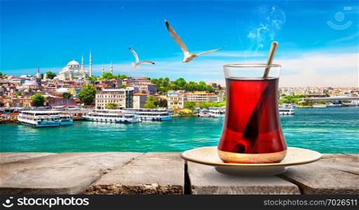 Tea in Golden Horn bay of Istanbul and view on Suleymaniye mosque, Turkey
