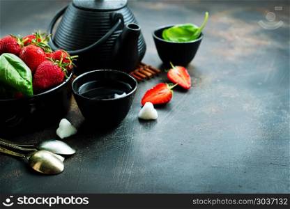 tea in teapot. Tea with fresh basil and strawberry, fresh herbal tea
