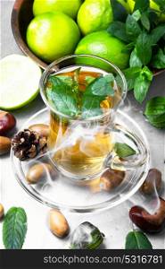 Tea lime mint. Hot tea with mint and lime on an autumn background