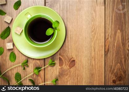 Tea mint with mint leaves on table background. Top view. Focus on tea