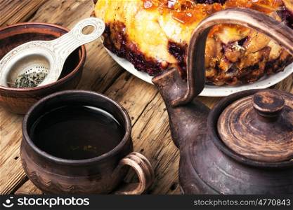 tea-party with rustic pastries. Clay tea ware with tea and homemade cake pie