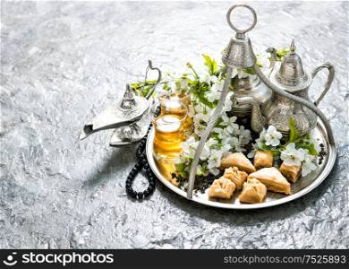Tea pot and glasses, sweets, traditional oriental delight baklava. Hari Raya Aidilfitri