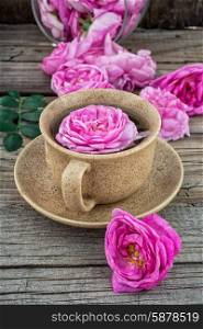 tea rose. Cup with fresh fragrant herbal decoction of tea rose.The image is tinted.Selective focus