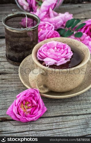 tea rose. Cup with fresh fragrant herbal decoction of tea rose.The image is tinted