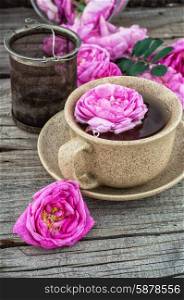 tea rose. Cup with fresh fragrant herbal decoction of tea rose.The image is tinted