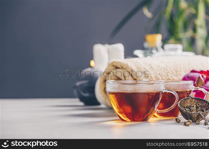 Tea set and spa settings on concrete background. Natural spa treatment and relaxation concept. Tea and SPA composition