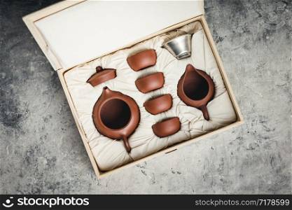 Tea set in the box on concrete background, flat lay. Tea set in the box on concrete background