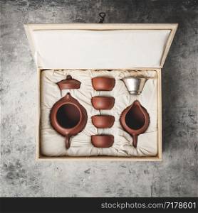 Tea set in the box on concrete background, flat lay. Tea set in the box on concrete background
