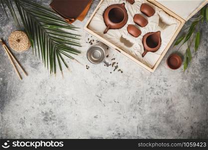 Tea set in the box on concrete background, flat lay, copy space. Tea set in the box on concrete background