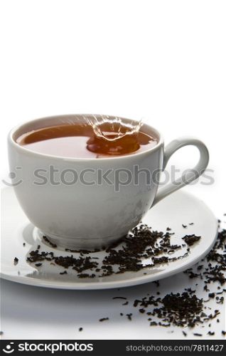 tea splash in white cup isolated