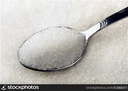 Tea spoon of white granulated sugar