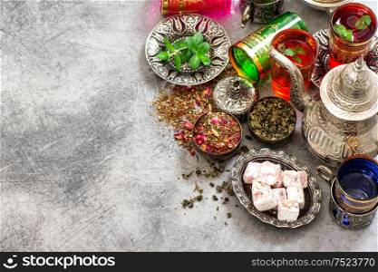 Tea table place setting with colorful glasses and oriental delights