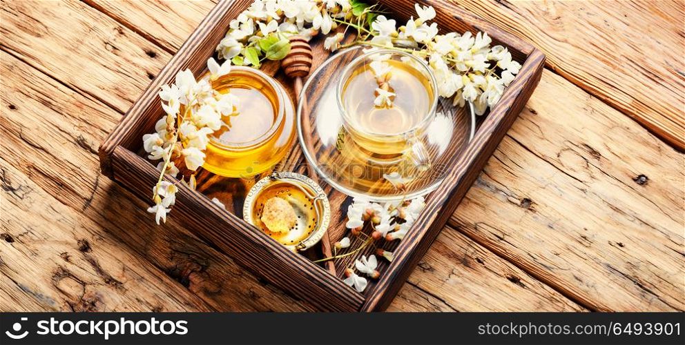 Tea with acacia flavor. Healing herbal tea with honey from acacia flowers.Herbal tea