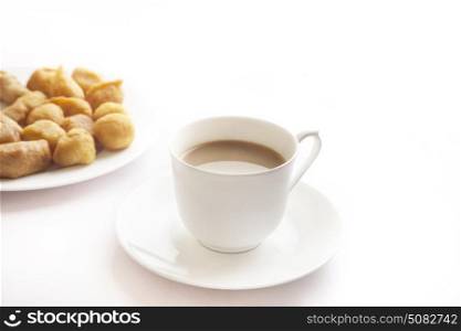 Tea with bhajiyas on white background