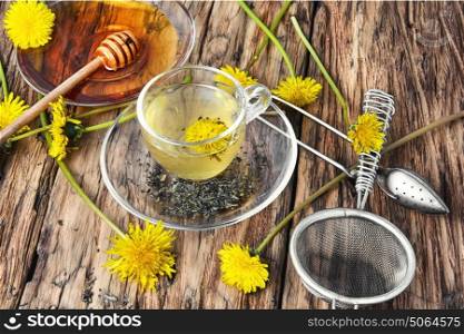 Tea with honey dandelion. Cup of medicinal tea with honey dandelion