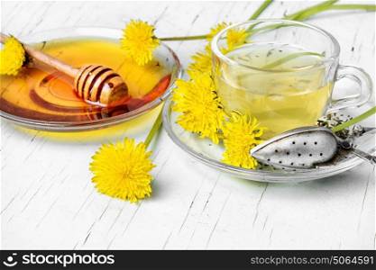 Tea with honey dandelion. Saucer with honey of dandelions and cup of herbal tea.Copy space