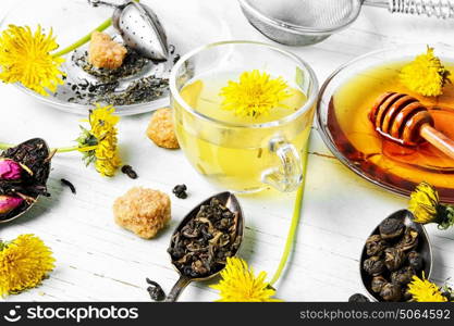 Tea with honey dandelion. saucer with honey of dandelions and cup of herbal tea